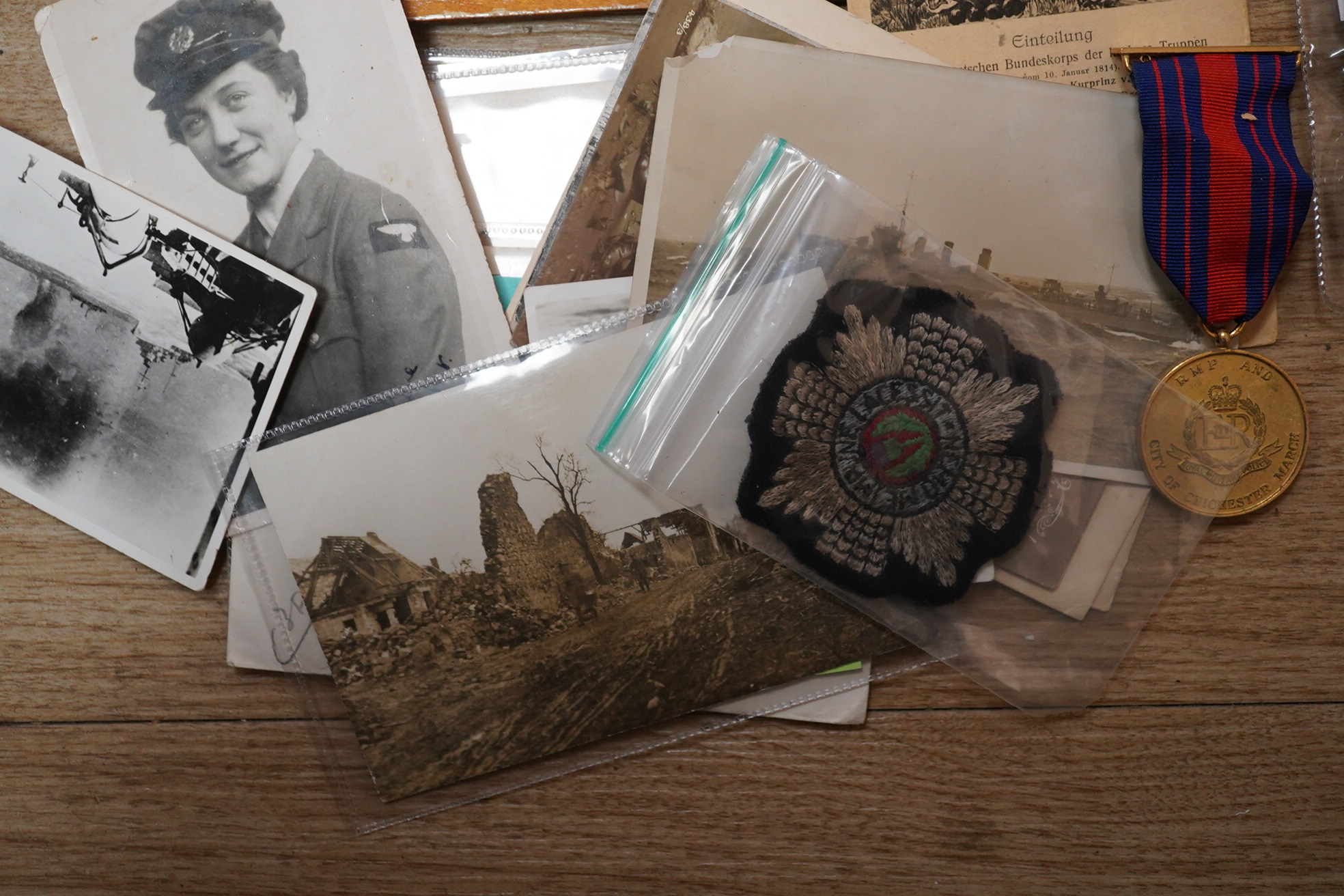 A quantity of various military ephemera to include a Coldstream guards matchbox holder, a death plaque and another 19th century glass plaque, buttons, badges, National Registration Identity Card, various photos and lette
